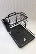 Modern 2-tier black metal dish drying rack with side utensil caddy and bottom drain tray on a kitchen countertop.