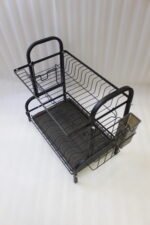 2-tier black metal dish drying rack with utensil holder and drip tray on a marble kitchen countertop