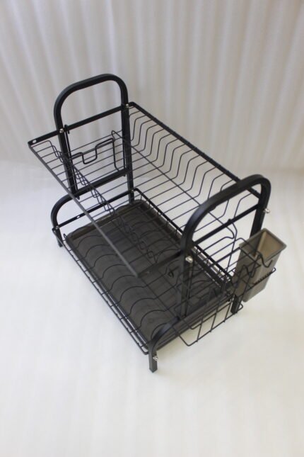 2-tier black metal dish drying rack with utensil holder and drip tray on a marble kitchen countertop
