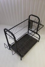 2-tier black metal dish drying rack with utensil holder and drip tray on a marble kitchen countertop