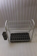 White 2-tier metal wire dish drying rack with removable dark gray drain tray and side utensil holder on a marble kitchen countertop.