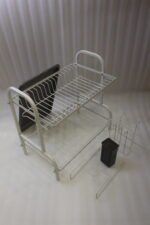 White 2-tier metal wire dish drying rack with removable dark gray drain tray and side utensil holder on a marble kitchen countertop.