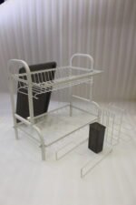 White 2-tier metal wire dish drying rack with removable dark gray drain tray and side utensil holder on a marble kitchen countertop.