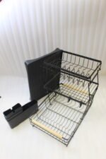 3-tier black wire dish drying rack on a marble countertop with wooden handles, attached utensil holder, and removable drip tray
