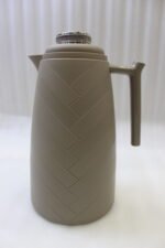 Three One More 1 Liter modern thermal vacuum flasks in charcoal grey, taupe beige, and white standing on a white kitchen marble countertop.
