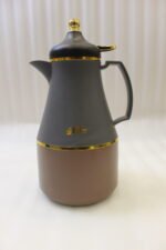Three 1-liter modern thermal vacuum flasks in matte black, off-white, and grey featuring gold trim on a kitcThree 1-liter modern thermal vacuum flasks in matte black, off-white, and grey featuring gold trim on a kitchen countertop.Three 1-liter modern thermal vacuum flasks in matte black, off-white, and grey featuring gold trim on a kitchen countertop.Three 1-liter modern thermal vacuum flasks in matte black, off-white, and grey featuring gold trim on a kitchen countertop.Three 1-liter modern thermal vacuum flasks in matte black, off-white, and grey featuring gold trim on a kitchen countertop.Three 1-liter modern thermal vacuum flasks in matte black, off-white, and grey featuring gold trim on a kitchen countertop.hen countertop.