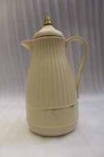 Three ONE MORE 1-liter ribbed luxury vacuum flasks in black, cream, and taupe with gold top finials on a marble kitchen counter.