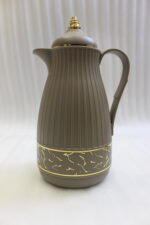 Three ONE MORE 1-liter ribbed luxury vacuum flasks in black, cream, and taupe with gold top finials on a marble kitchen counter.