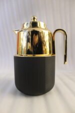 Three One More 1 liter luxury thermal vacuum flasks in black, white, and grey with polished gold tops on a marble kitchen countertop.