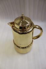 Polished metallic gold 1-liter thermal vacuum flask for coffee and tea displayed on a marble kitchen countertop